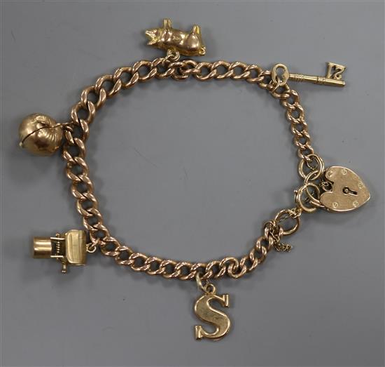 A 9ct gold charm bracelet, hung with five assorted charms.